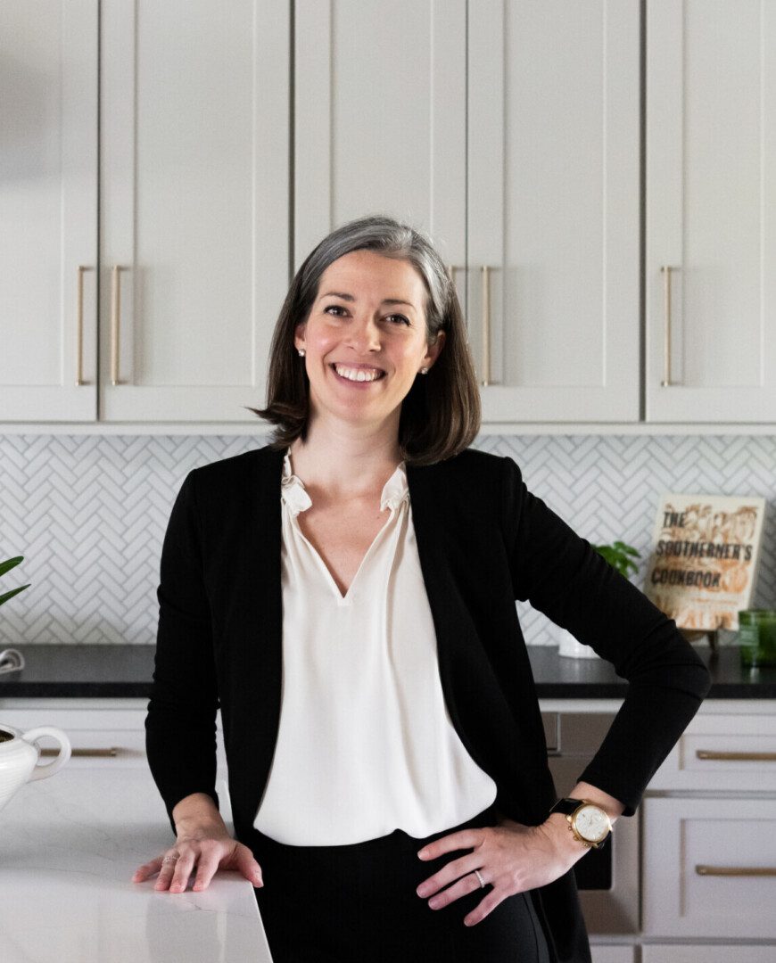 Smiling woman standing in modern kitchen